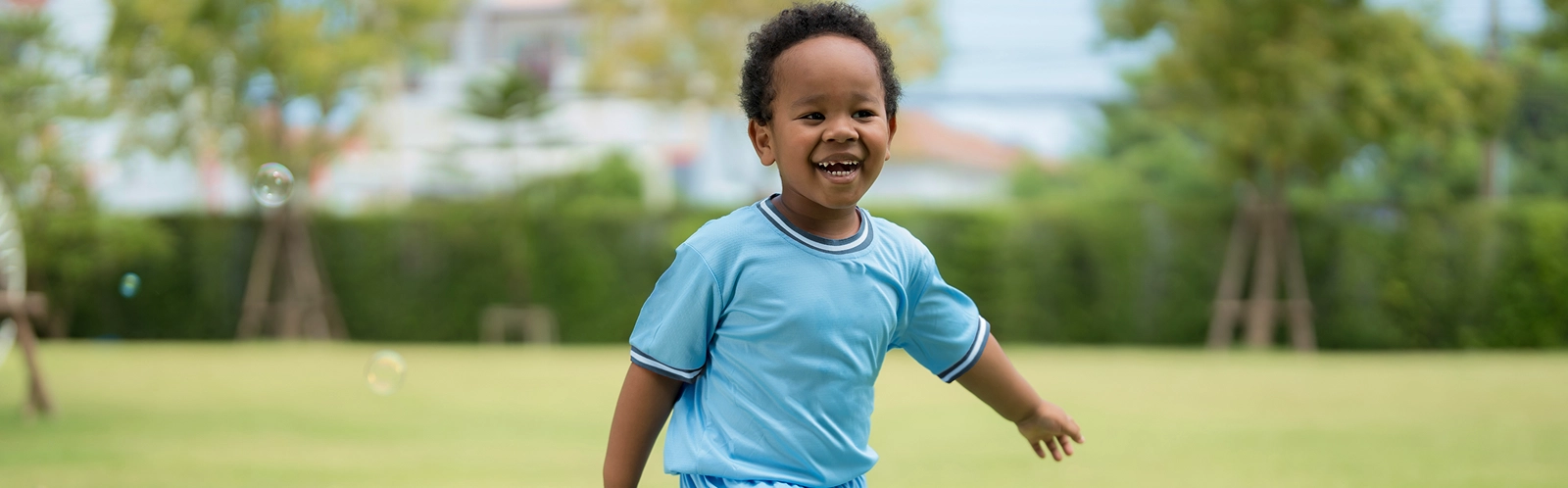 cute-little-boy-playing-with-soap-bubbles-park-clear-day 1