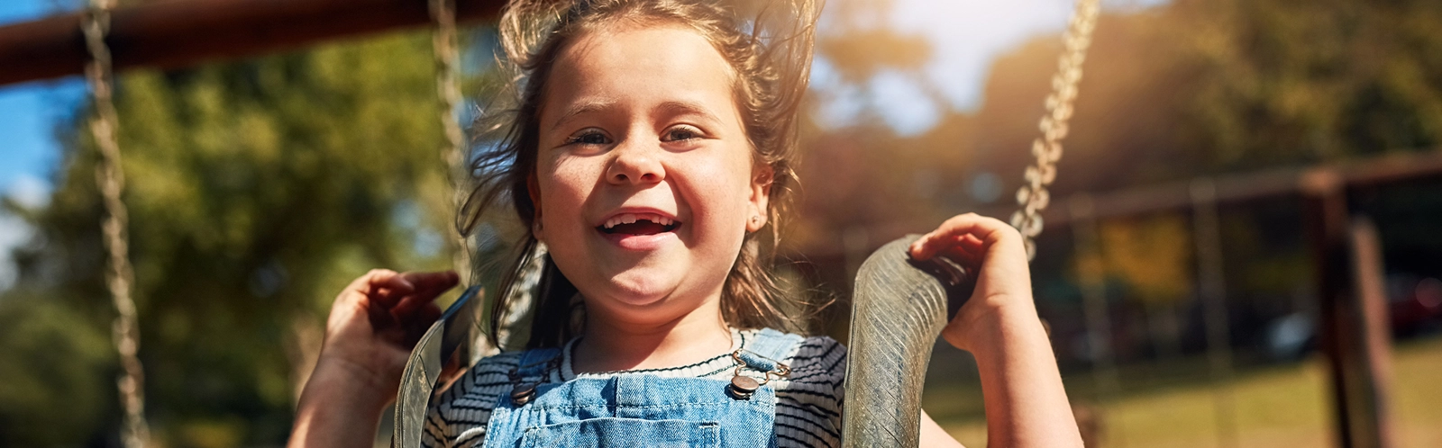 happy-portrait-girl-outdoor-swing-summer-vacation-with-freedom-brother-bonding-park-smile-young-child-laugh-playground-with-boy-school-holiday-growth-development 1