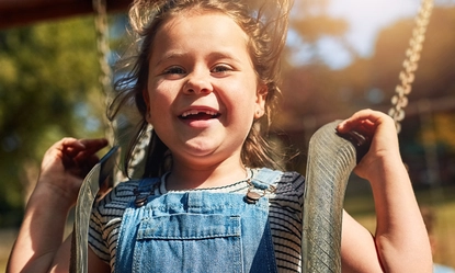 happy-portrait-girl-outdoor-swing-summer-vacation-with-freedom-brother-bonding-park-smile-young-child-laugh-playground-with-boy-school-holiday-growth-development 1
