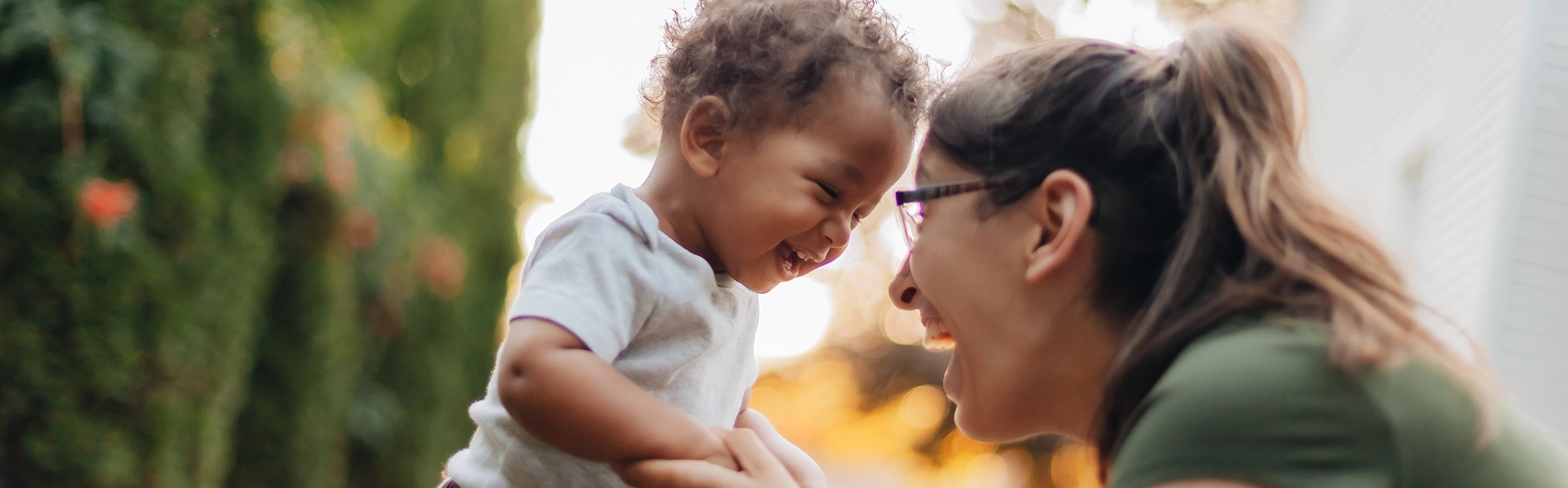 smiling-mother-with-son-playing-outdoors