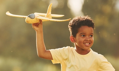 yellow-plane-hands-african-american-kid-have-fun-field-summer-daytime